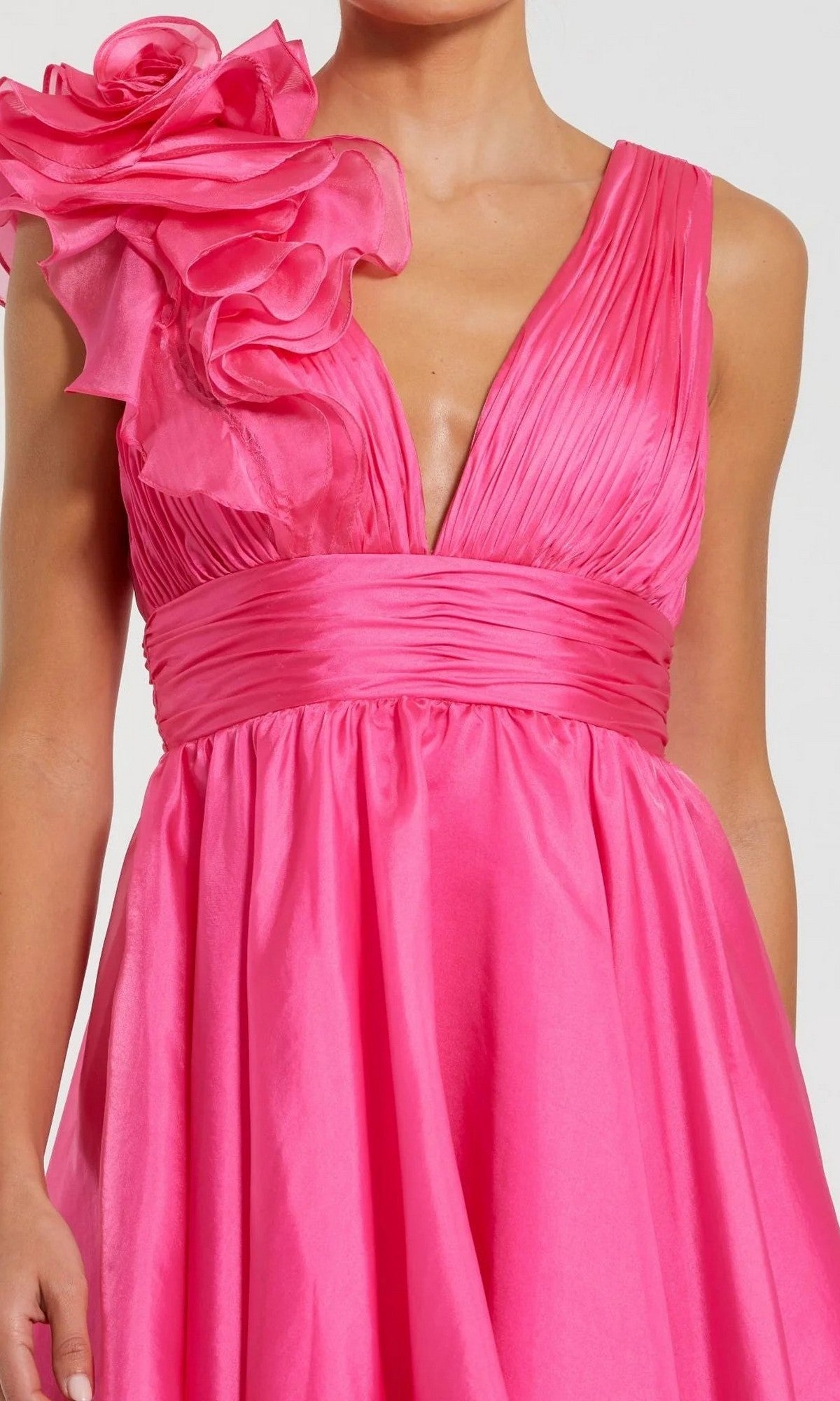 Woman wearing the Mac Duggal 48952 Ruffle Short White Party Dress featuring a sleeveless design, pleated details, deep V-neckline, and a large ruffled flower accent—ideal for any semi-formal occasion.